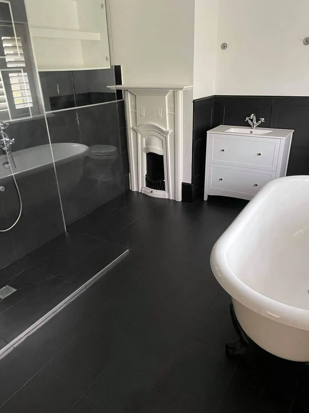 A white bath tub sitting next to a walk in shower.